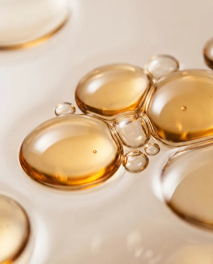 Macro of golden vitamin E oil droplets.